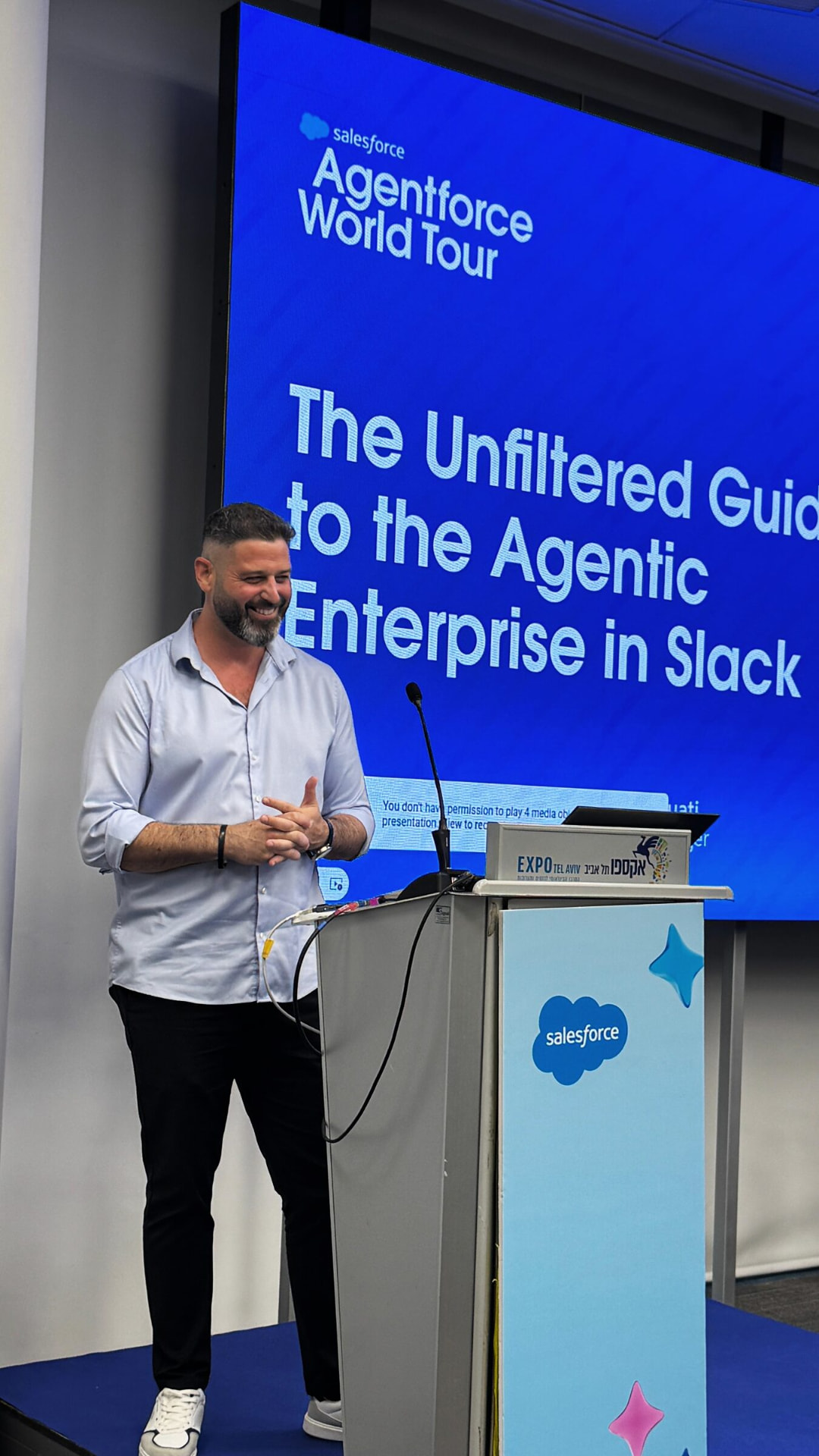 Liron Kaplan speaking on stage at a Salesforce Agentforce event