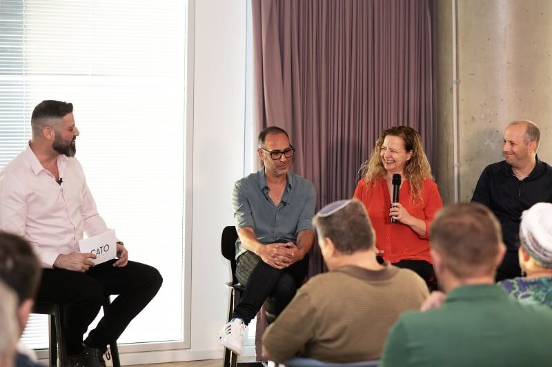 Liron Kaplan hosting a panel conversation with Cato Networks leaders in front of a seated audience