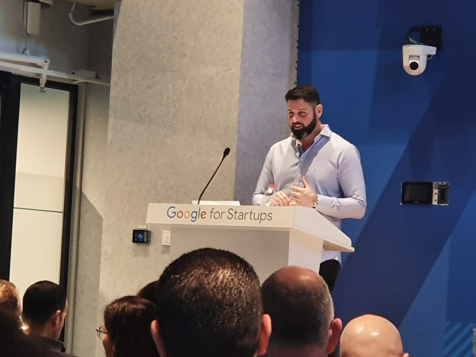 Liron Kaplan presenting on stage at a Google for Startups event